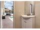 A simple powder room with a vanity offers a view into the lanai and pool area at 1201 Shelter Rock Rd, Orlando, FL 32835