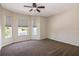 Well-lit bedroom with multiple windows and plush carpeting at 1201 Shelter Rock Rd, Orlando, FL 32835
