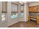 Charming breakfast nook featuring custom blinds and large windows with clear views of the inviting pool area at 1201 Shelter Rock Rd, Orlando, FL 32835