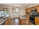 Bright breakfast nook area with a kitchen island, and views of the backyard through large windows with custom blinds at 1201 Shelter Rock Rd, Orlando, FL 32835