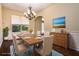 Bright dining room featuring a wooden table, chandelier, and large window for ample natural light at 1201 Shelter Rock Rd, Orlando, FL 32835