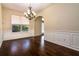 Formal dining room with hardwood floors, wainscoting, and a classic chandelier at 1201 Shelter Rock Rd, Orlando, FL 32835