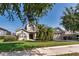 Inviting home featuring a well-kept lawn, mature trees, and a convenient two-car garage at 1201 Shelter Rock Rd, Orlando, FL 32835