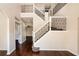 Elegant foyer with a staircase featuring decorative iron railings and hardwood floors throughout the entry at 1201 Shelter Rock Rd, Orlando, FL 32835