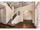 Spacious foyer with high ceilings, staircase, hardwood floors, and archway into living room at 1201 Shelter Rock Rd, Orlando, FL 32835