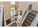 Welcoming foyer featuring a staircase, chandelier, and decorative glass front doors at 1201 Shelter Rock Rd, Orlando, FL 32835