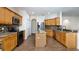 Spacious kitchen featuring wood cabinets, an island, stainless appliances, and granite countertops, offering ample workspace at 1201 Shelter Rock Rd, Orlando, FL 32835