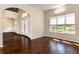 Bright living room with hardwood floors and archways into the foyer at 1201 Shelter Rock Rd, Orlando, FL 32835