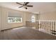 Open loft space with neutral carpet, ceiling fan, and view of the entry at 1201 Shelter Rock Rd, Orlando, FL 32835