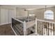 Upstairs loft area with decorative railings overlooking the main floor at 1201 Shelter Rock Rd, Orlando, FL 32835