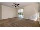 Well-lit main bedroom showcasing a ceiling fan and sliding glass door with pool view at 1201 Shelter Rock Rd, Orlando, FL 32835