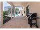 Covered patio with grill looking towards the pool in the backyard at 1201 Shelter Rock Rd, Orlando, FL 32835