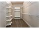 Spacious walk-in closet with multiple shelves and hanging rods for organized storage at 1201 Shelter Rock Rd, Orlando, FL 32835