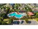 Aerial view of a community pool and recreational area surrounded by residential homes and lush landscaping at 1265 Blarney St, Minneola, FL 34715