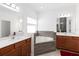 Bathroom with double vanity, soaking tub, and tiled surround at 1265 Blarney St, Minneola, FL 34715
