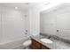 Bright bathroom featuring granite countertop, bathtub and shower combo at 1265 Blarney St, Minneola, FL 34715