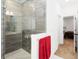 Bathroom featuring a tiled shower and a view into an adjacent bedroom at 1265 Blarney St, Minneola, FL 34715