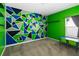 A bedroom featuring dynamic wall art, gray carpet and a naturally lit sitting area with a small desk at 1265 Blarney St, Minneola, FL 34715