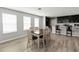 Open dining area with a dining table and chairs with adjacent kitchen at 1265 Blarney St, Minneola, FL 34715