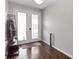 Bright foyer with wood flooring and glass paneled double doors with an ornamental coat rack at 1265 Blarney St, Minneola, FL 34715