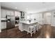 Bright kitchen with white cabinets, stainless appliances, and a large granite island with seating at 1265 Blarney St, Minneola, FL 34715