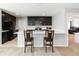 Modern kitchen with dark cabinets, white countertops, and stainless steel appliances at 1265 Blarney St, Minneola, FL 34715