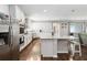 Open kitchen with white cabinets, granite countertops, stainless appliances, and a breakfast bar at 1265 Blarney St, Minneola, FL 34715