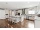 Bright kitchen with white cabinetry, stainless steel appliances, tile backsplash, and a large center island at 1265 Blarney St, Minneola, FL 34715
