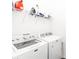 Laundry room with white washer, dryer, and wire shelf at 1265 Blarney St, Minneola, FL 34715