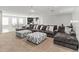 Expansive living room with plush sofa, ottomans, and plenty of space for relaxation at 1265 Blarney St, Minneola, FL 34715