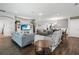 Open-concept living area with wood floors, sofas, a media center, and adjacent dining area and staircase at 1265 Blarney St, Minneola, FL 34715