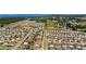 Overhead shot of a thriving suburban community, situated near a picturesque lake, blending nature and residential living at 1265 Blarney St, Minneola, FL 34715