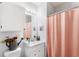 Bathroom features a vanity sink, mirrored cabinet, and a charming shower curtain at 1325 Lake Shadow Cir # 12303, Maitland, FL 32751
