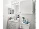 Clean bathroom with white cabinetry, a decorative mirror, and standard fixtures at 1325 Lake Shadow Cir # 12303, Maitland, FL 32751