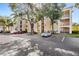 Exterior view of the complex building with parking and landscaping at 1325 Lake Shadow Cir # 12303, Maitland, FL 32751
