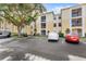 Multi-story condo building with ample parking, mature landscaping, and screened-in balconies at 1325 Lake Shadow Cir # 12303, Maitland, FL 32751