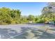 Well-maintained tennis court surrounded by lush greenery and trees at 1325 Lake Shadow Cir # 12303, Maitland, FL 32751