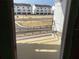 A new home's private balcony offering views of the neighborhood street, showcasing the modern exterior of neighboring townhomes at 15465 Hamlin Park Drive, Winter Garden, FL 34787
