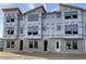 Townhome construction featuring multiple windows and sturdy block foundation protected with Typar weather-resistant wrap at 15465 Hamlin Park Drive, Winter Garden, FL 34787