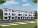 Modern townhome exteriors showcasing clean lines and neutral color palettes, enhanced by blue skies and lush landscaping at 15465 Hamlin Park Drive, Winter Garden, FL 34787