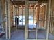 Interior view of a home under construction, with exposed framing, visible wiring and plumbing, on a concrete slab at 15465 Hamlin Park Drive, Winter Garden, FL 34787