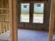 Interior view of a home under construction, featuring framed walls, windows and a concrete slab floor at 15465 Hamlin Park Drive, Winter Garden, FL 34787