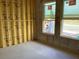 Interior view of a home under construction, showcasing framed walls, windows, and a concrete block base at 15465 Hamlin Park Drive, Winter Garden, FL 34787