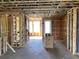 New construction shows an open-concept floor plan with framing and utilities visible, highlighting the modern layout and future potential at 15465 Hamlin Park Drive, Winter Garden, FL 34787