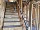 A stairway under construction showing the framing, plywood, and temporary railing leading to the next level of the home at 15465 Hamlin Park Drive, Winter Garden, FL 34787