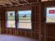 Framing of new construction showcasing window view, with visible studs and outdoor landscape at 15465 Hamlin Park Drive, Winter Garden, FL 34787