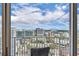 Balcony view overlooking the city skyline and blue sky with white clouds at 155 S Court Ave # 1909, Orlando, FL 32801