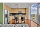 Open kitchen area featuring an island, granite countertops, wood floors, and a large window offering views at 155 S Court Ave # 1909, Orlando, FL 32801