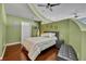 Modern main bedroom with wood floors, neutral bedding, and bedside storage at 155 S Court Ave # 1909, Orlando, FL 32801