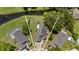 Aerial view of a home nestled between neighboring houses, offering glimpses of a serene pond nearby at 1748 Harvest Cv, Winter Park, FL 32792